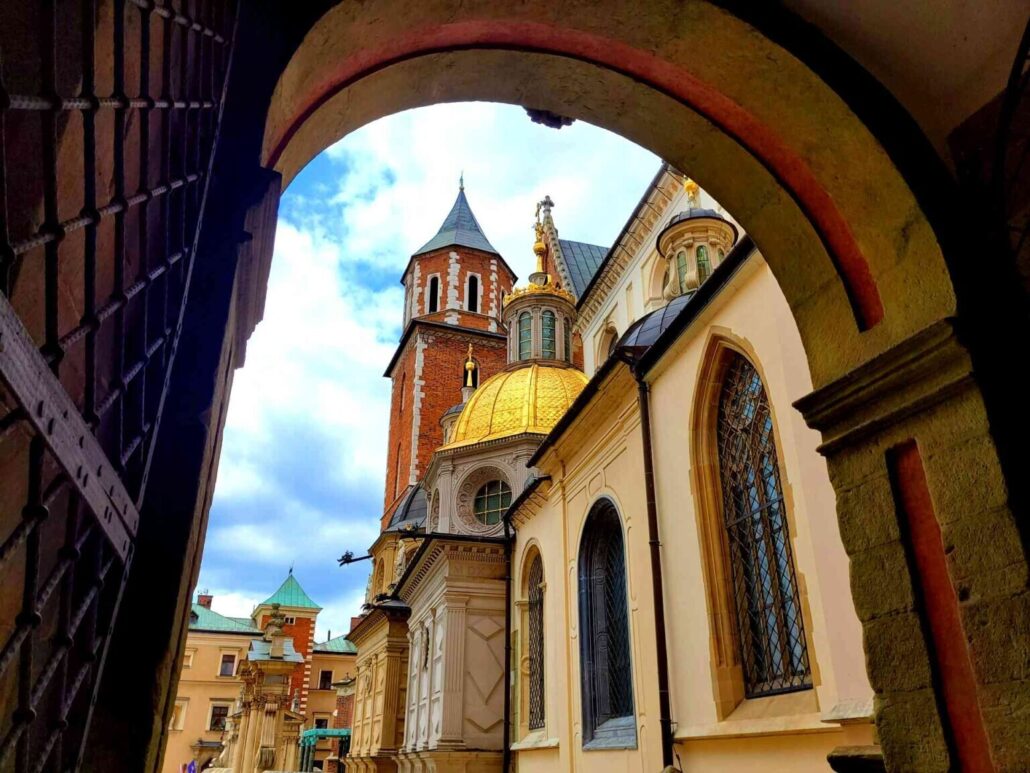 Atcracow Tour Arched Gate Golden Dome Brick Tower 