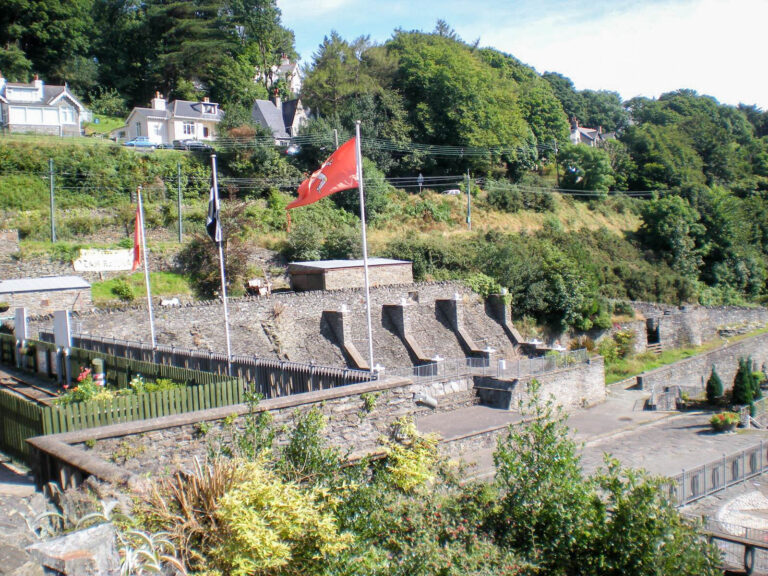 Guidedtoursofmann Tour Stone Wall Flags Greenery