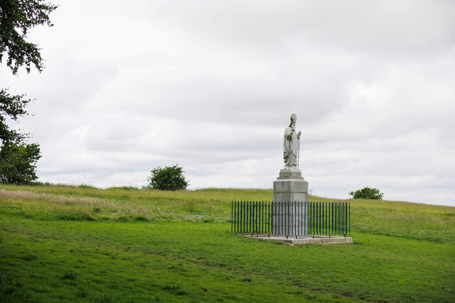 Touristy Tour Statue Grassy Hill Cloudy Sky